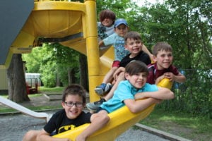 Photo of young boys on a playground slide