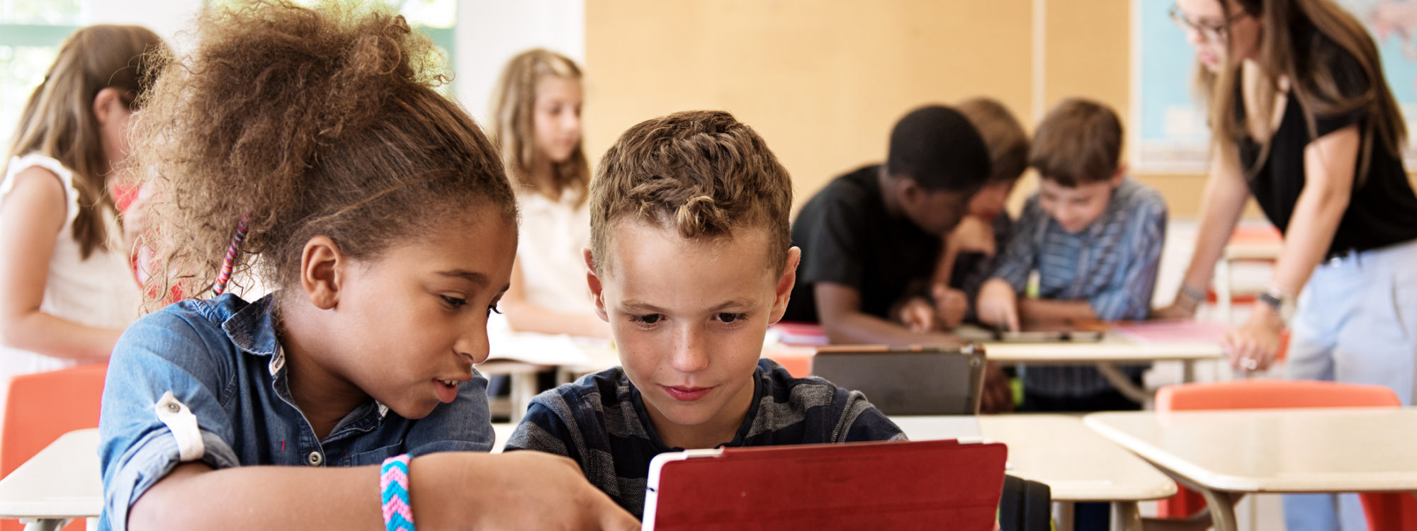 School kids in class using a digital tablet