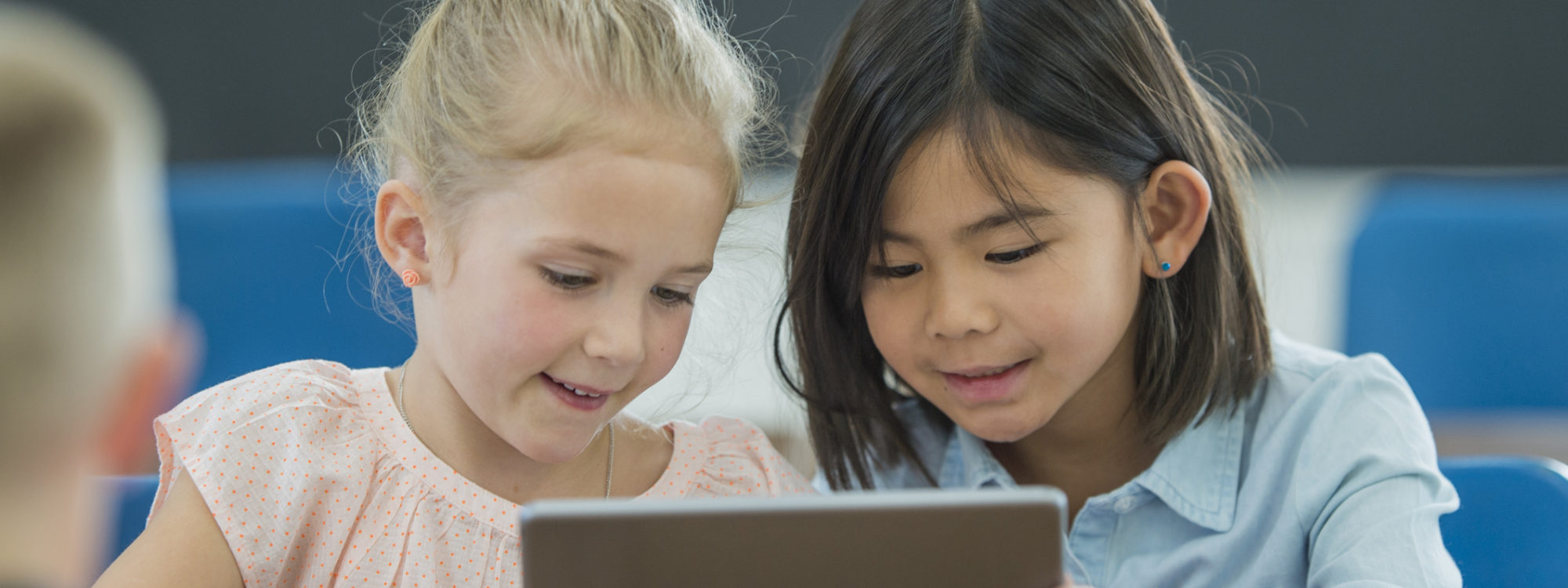 two students sharing tablet device