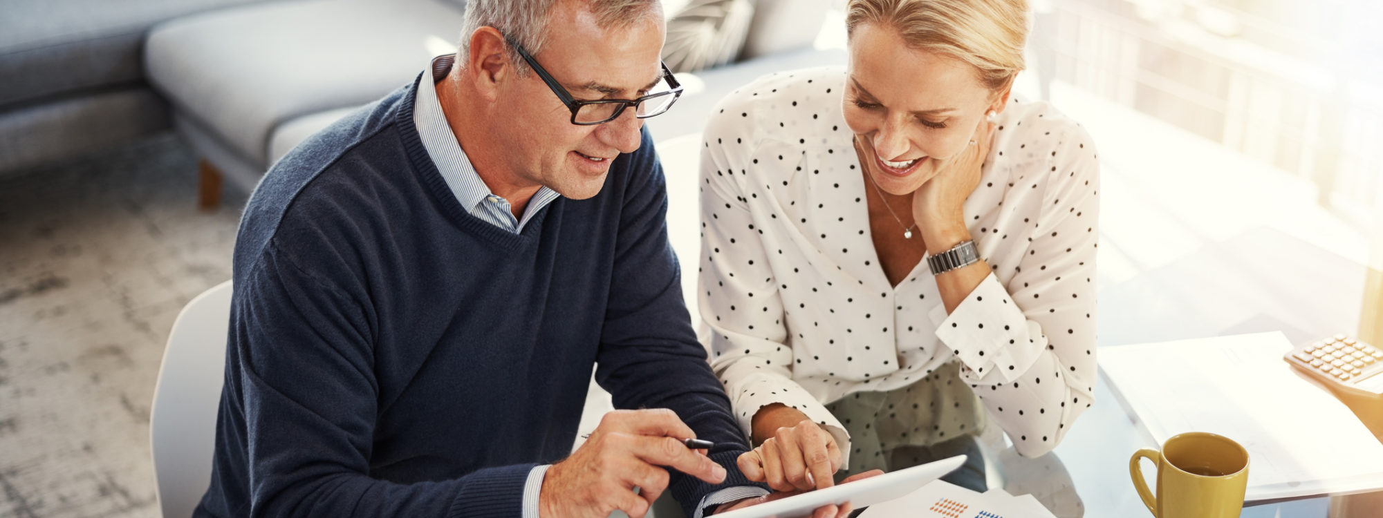 couple using tablet device at table