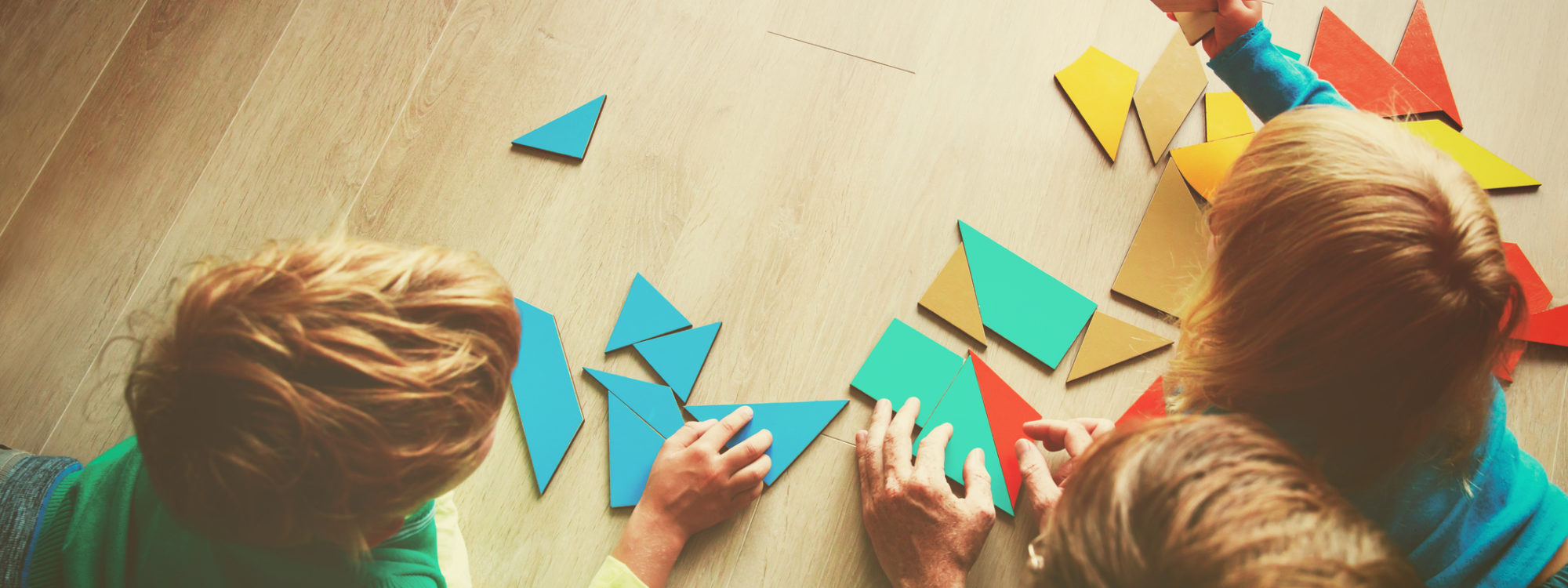 teacher and kids playing with geometric shapes, learning concept