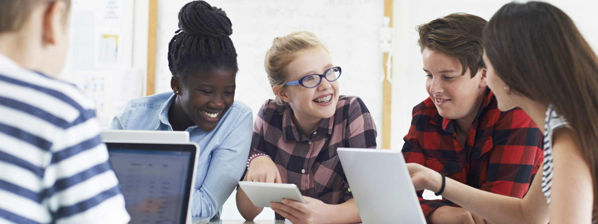 Group Of Teenage Students Collaborating On Project In IT Class