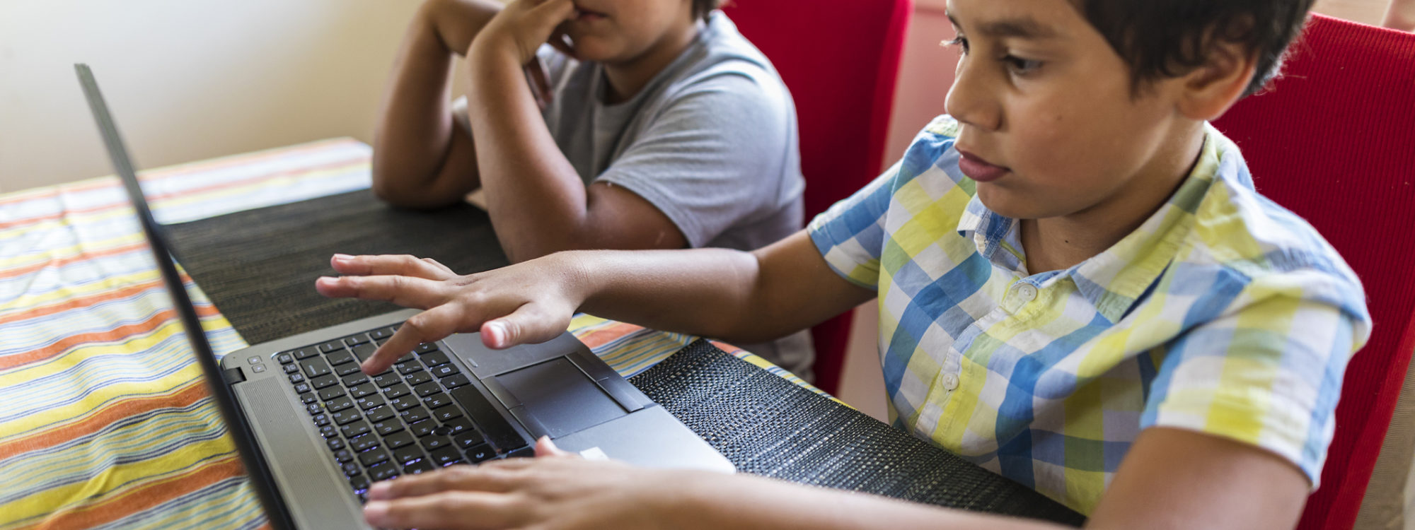 students sharing laptop