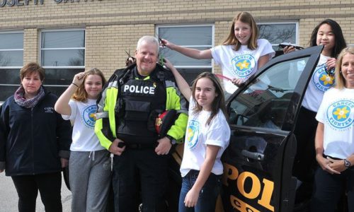 student posing with community officer