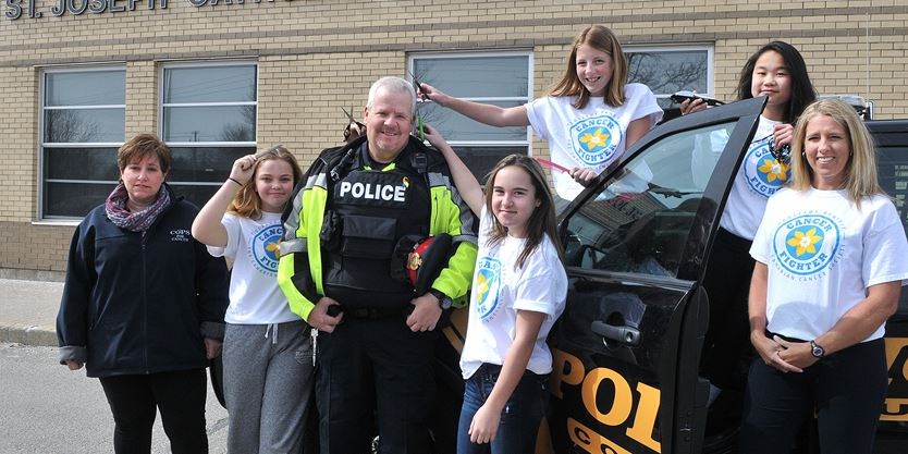 student posing with community officer