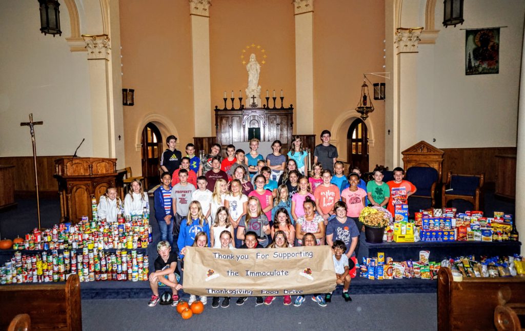 students standing with school food drive collection