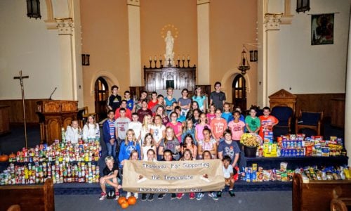students standing with school food drive collection