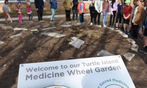Students standing around Medicine Wheel Garden