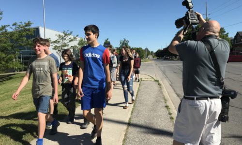students walking on sidewalk