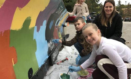 students painting snowplow blade