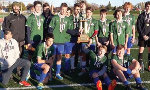 boys soccer team with medals