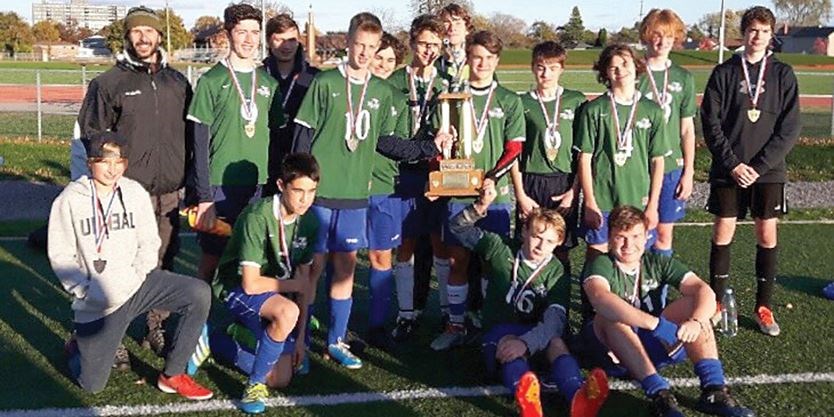 boys soccer team with medals