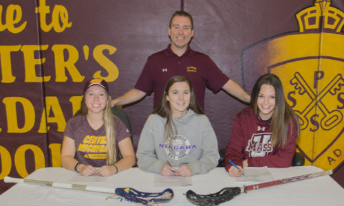 students at table with lacrosse sticks