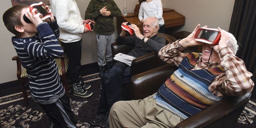 students and seniors using VR googles