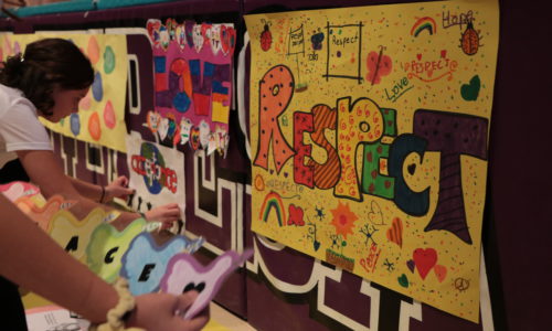 student creating Respect posters