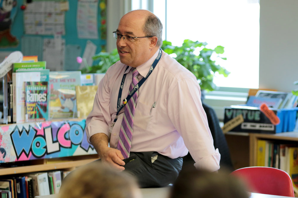 Director Michael Nasello sitting while addressing class