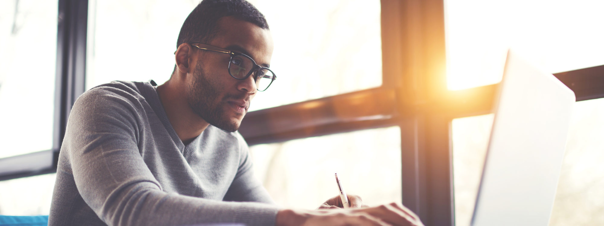 man working at desk with computer
