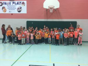 students and staff wearing orange shirts