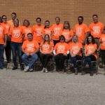 staff wearing orange shirts