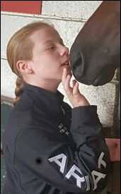 girl touching horse's nose