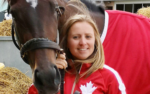 girl standing with horse