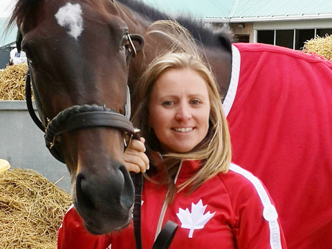 girl standing with horse