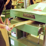 student using wood planner