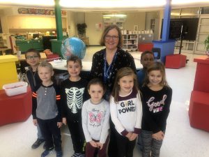 woman standing with a group of children