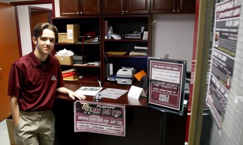 student staying next to work desk