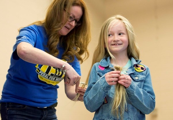 student getting hair trimmed