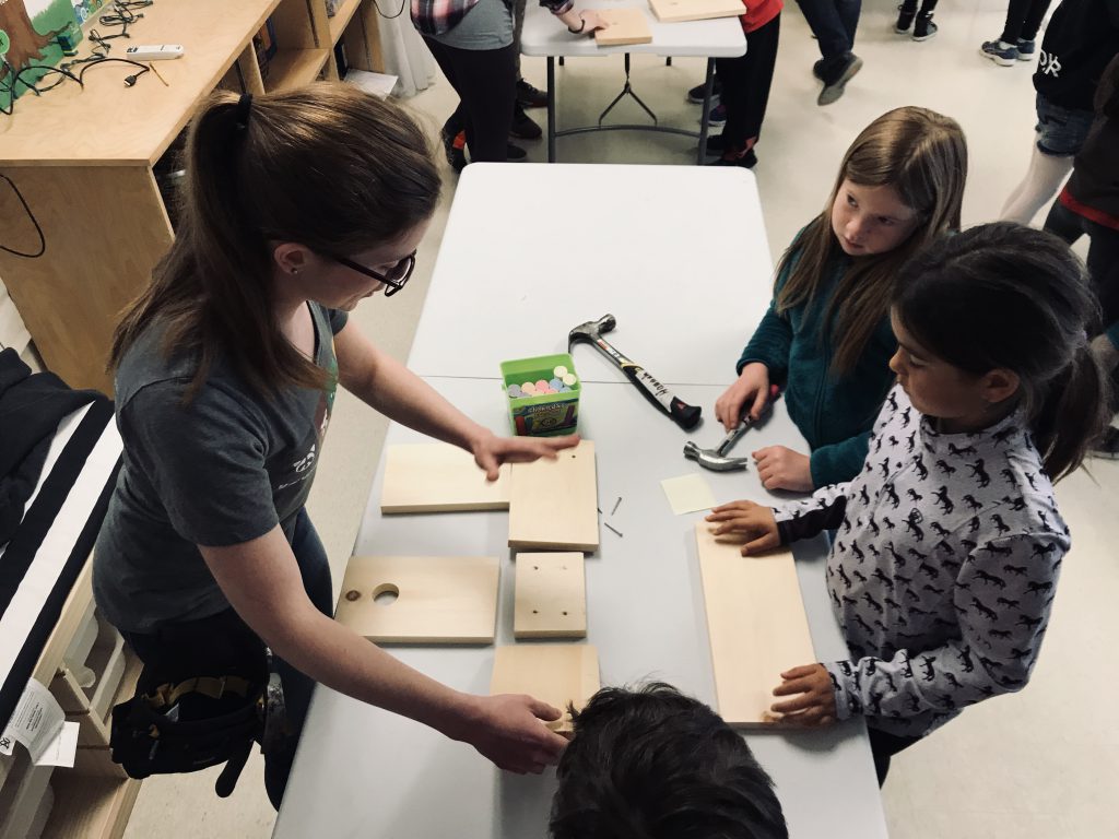 student building a bird house