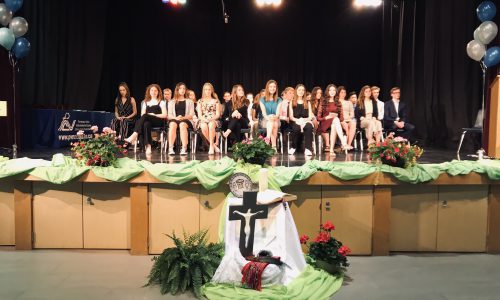 students sitting in chairs on stage