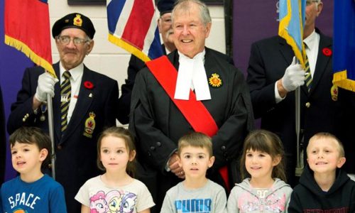 Man standing with students at ceremony