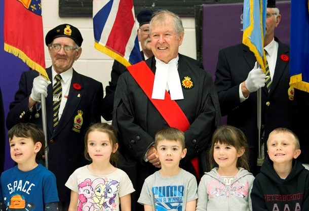 Man standing with students at ceremony