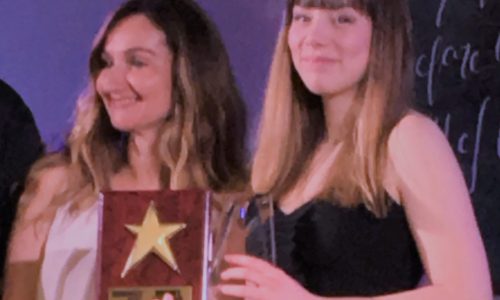 student holding awards