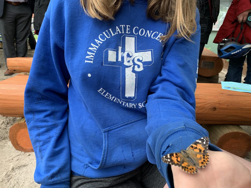 student holding butterfly