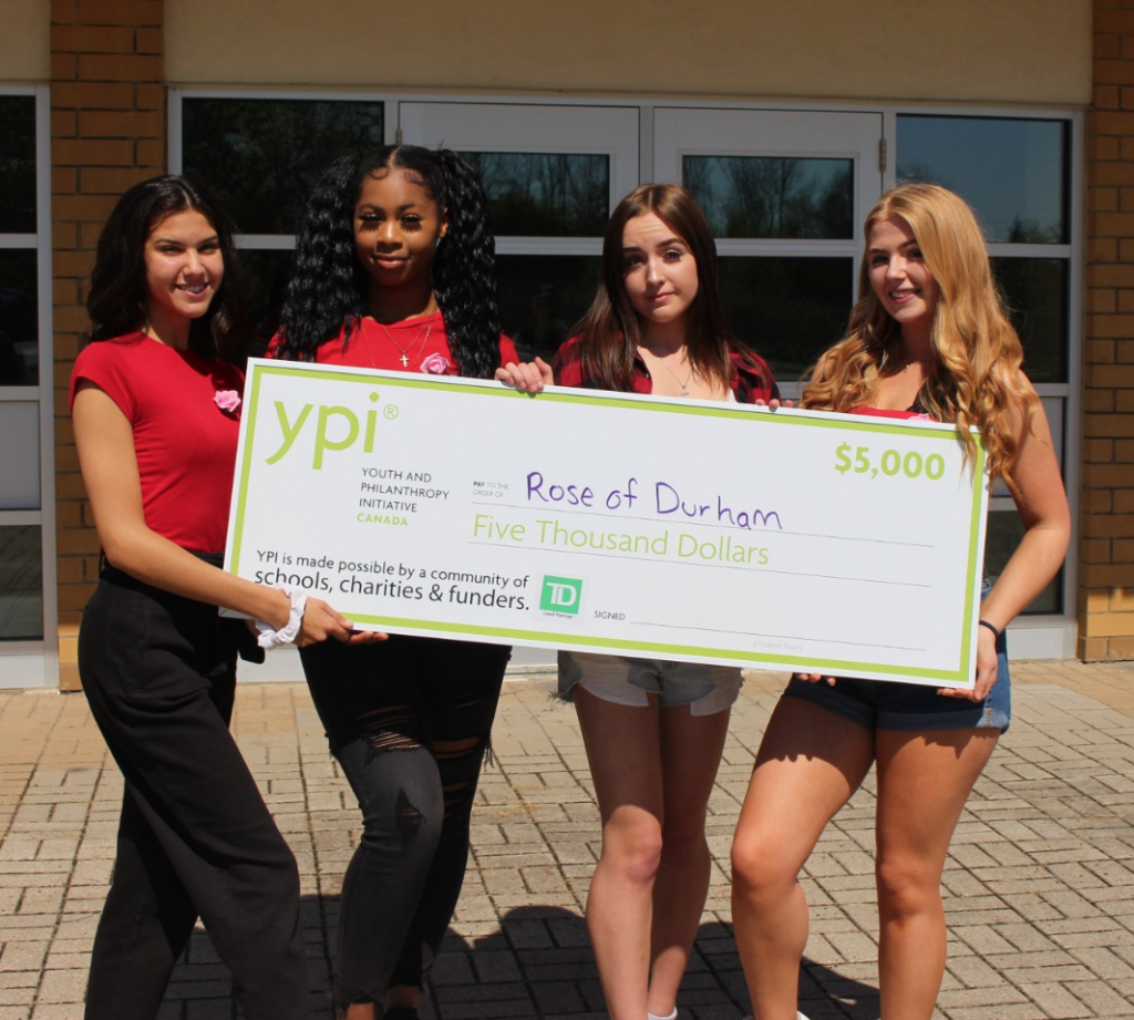 students holding decorative cheque