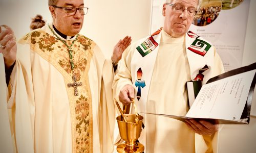 two priests performing mass
