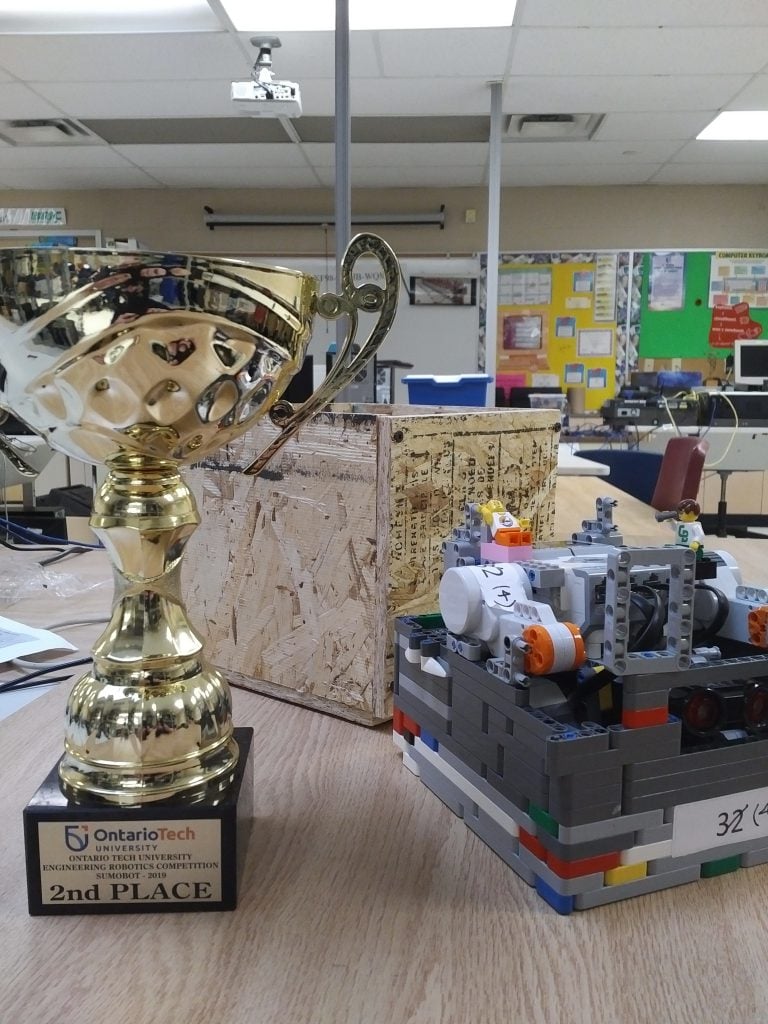 2nd place trophy next to lego robot