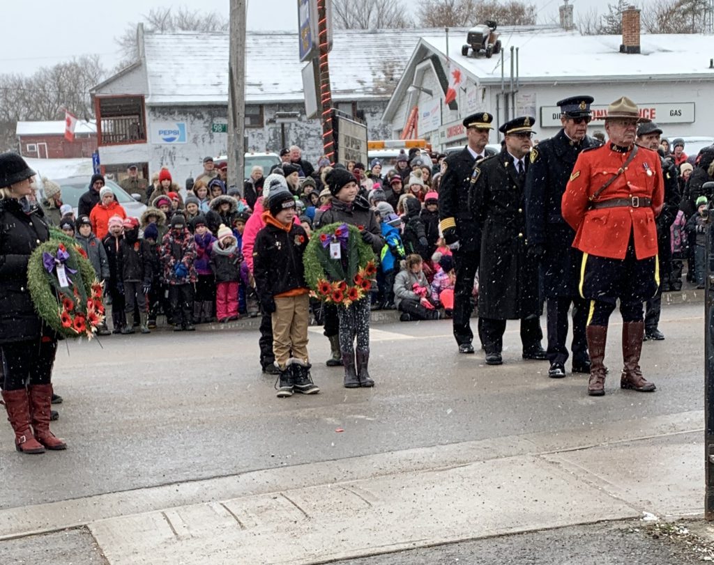 student holding wreath during ceremony