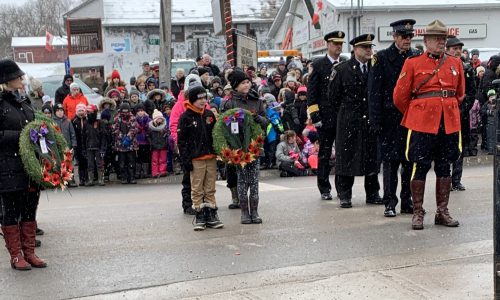 student holding wreath during ceremony