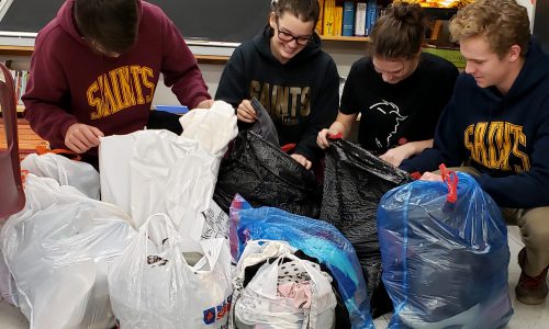 students with donations of clothing for Community Drive