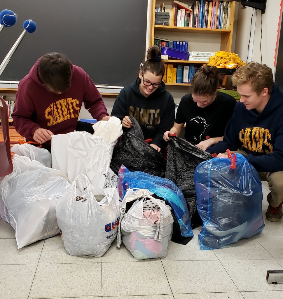 students with donations of clothing for Community Drive