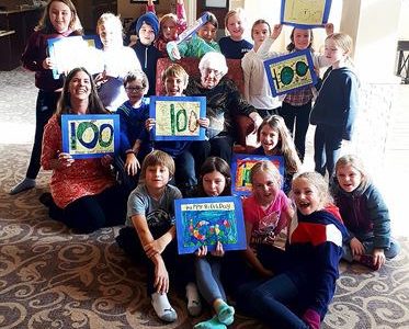 student group holding 100th birthday cards