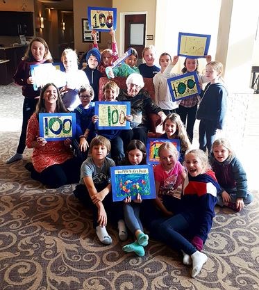 student group holding 100th birthday cards