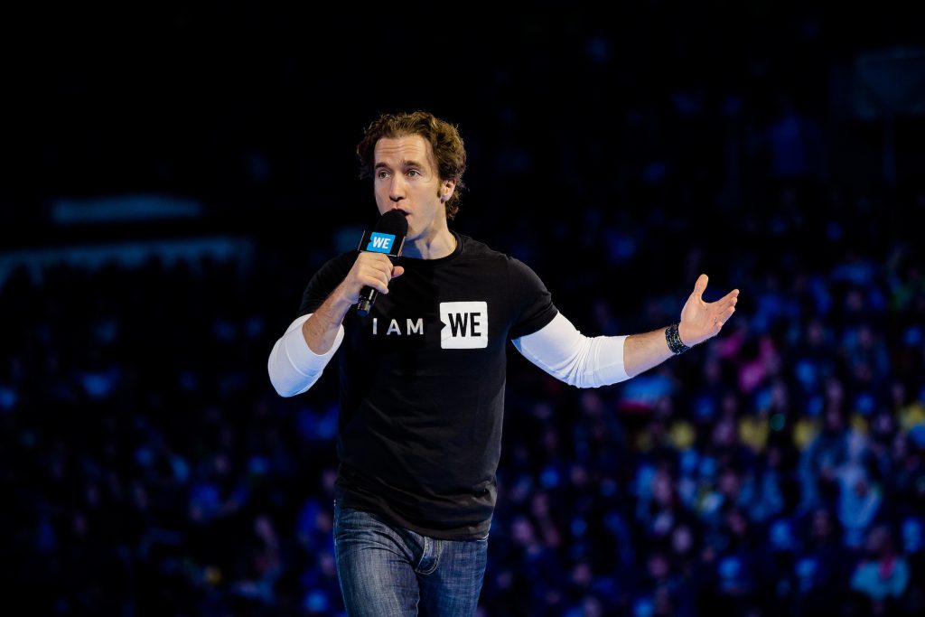 man speaking holding microphone at WE DAY