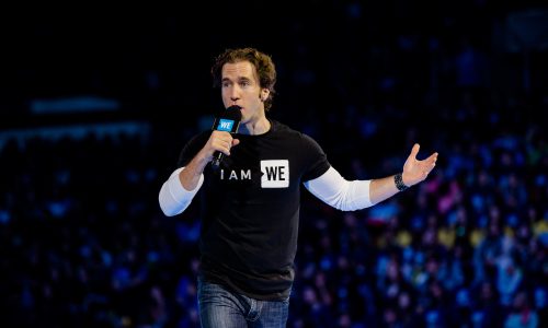 man speaking holding microphone at WE DAY