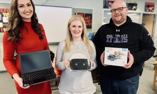 teachers holding various items of school techonology