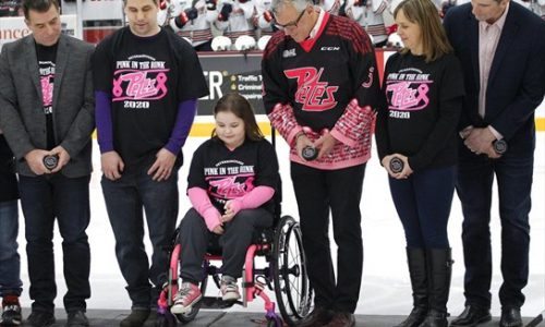 girl in wheelchair performs puck drop for Pink in the Rink