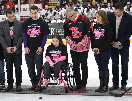 girl in wheelchair performs puck drop for Pink in the Rink